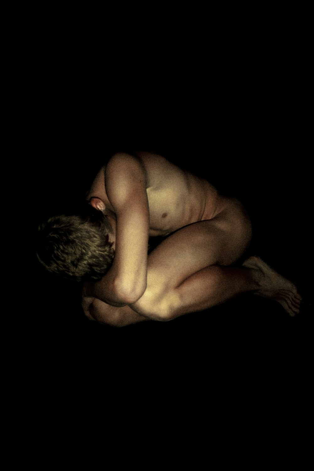 topless man with black background