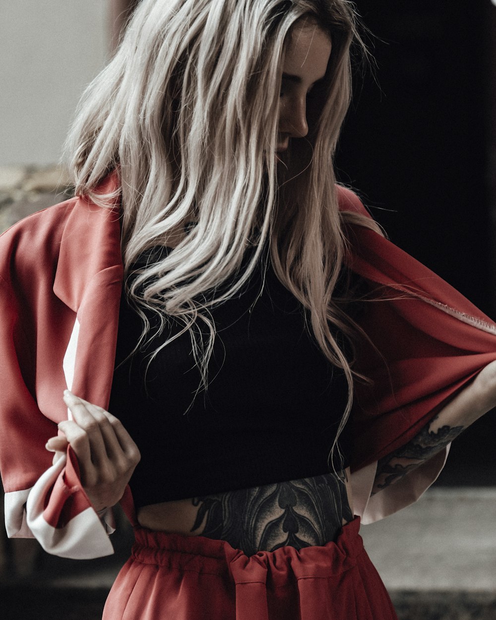 woman in black long sleeve shirt and red cardigan