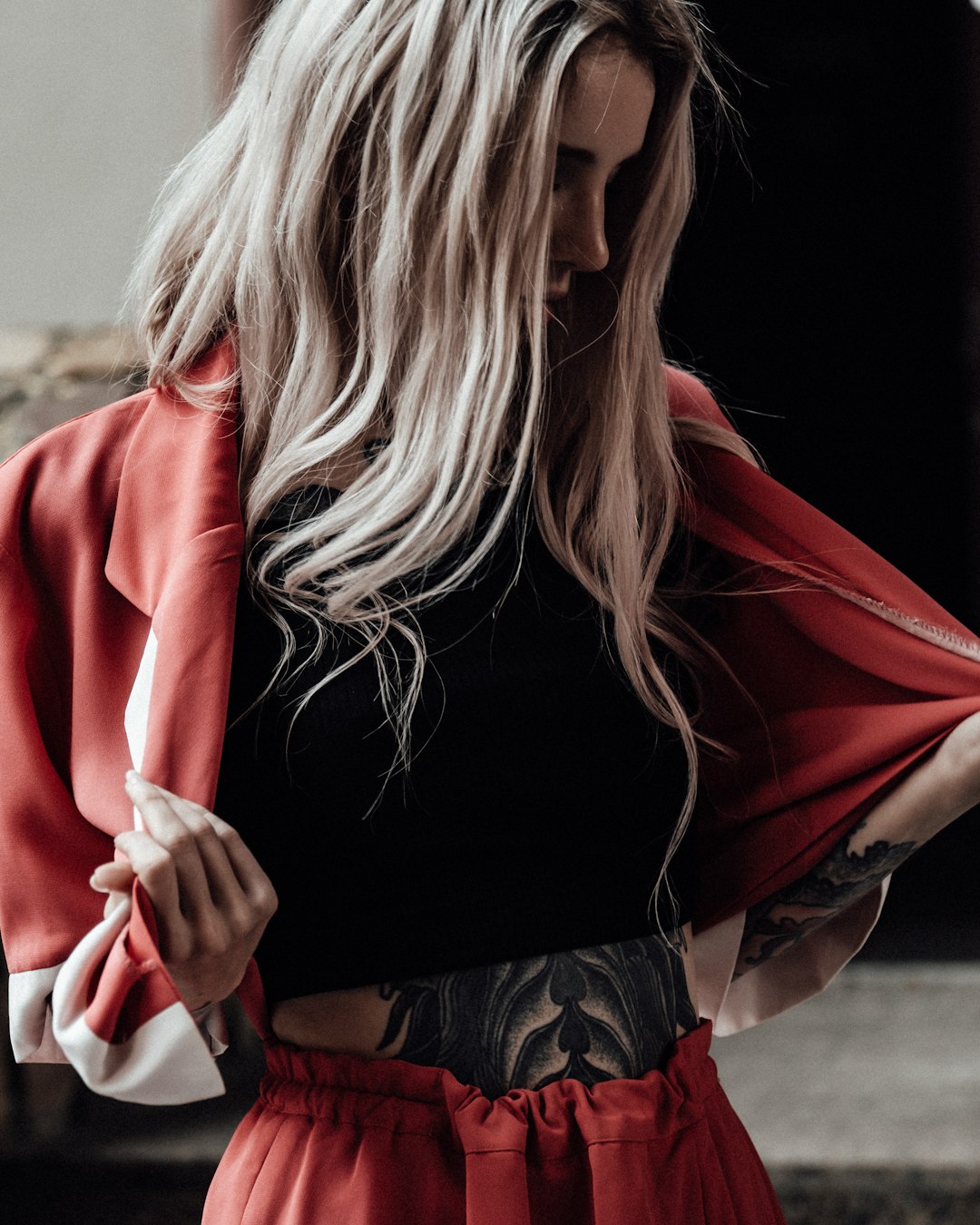 woman in black long sleeve shirt and red cardigan