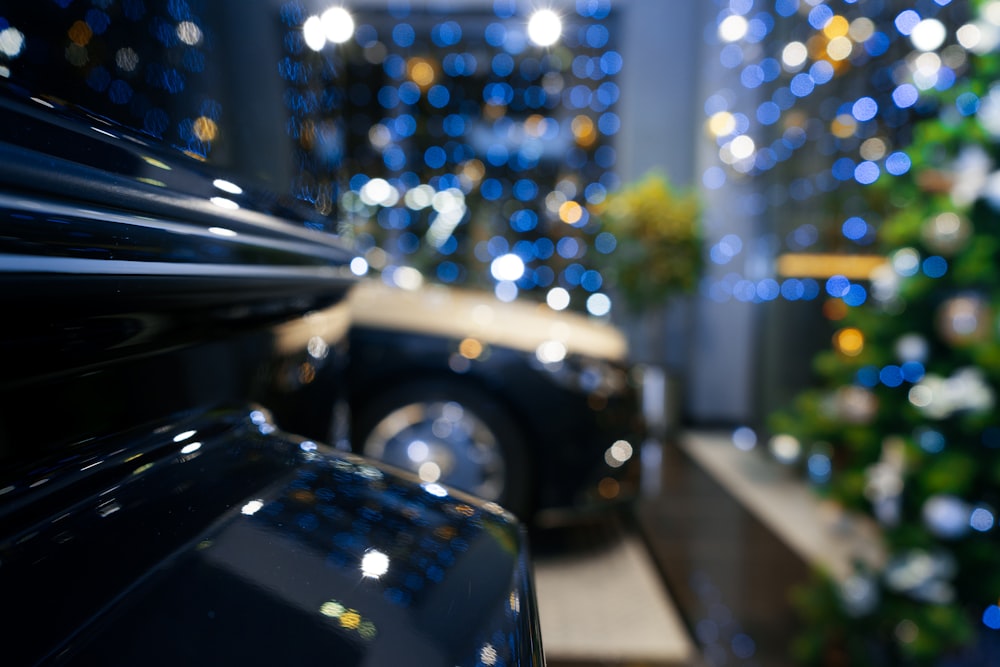 black car in front of white building during night time