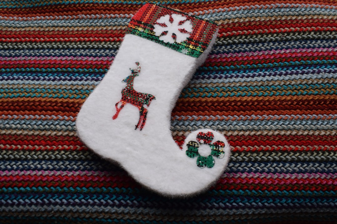 white and red sock on blue and red textile