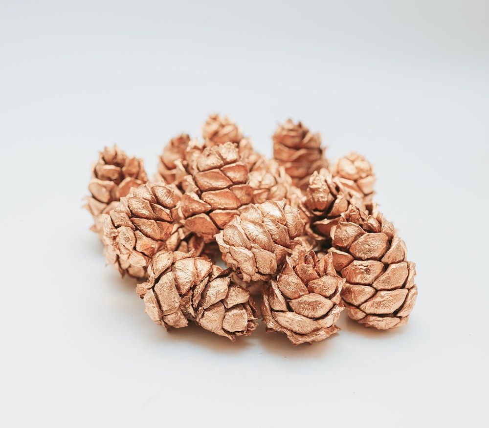 brown pine cone on white surface