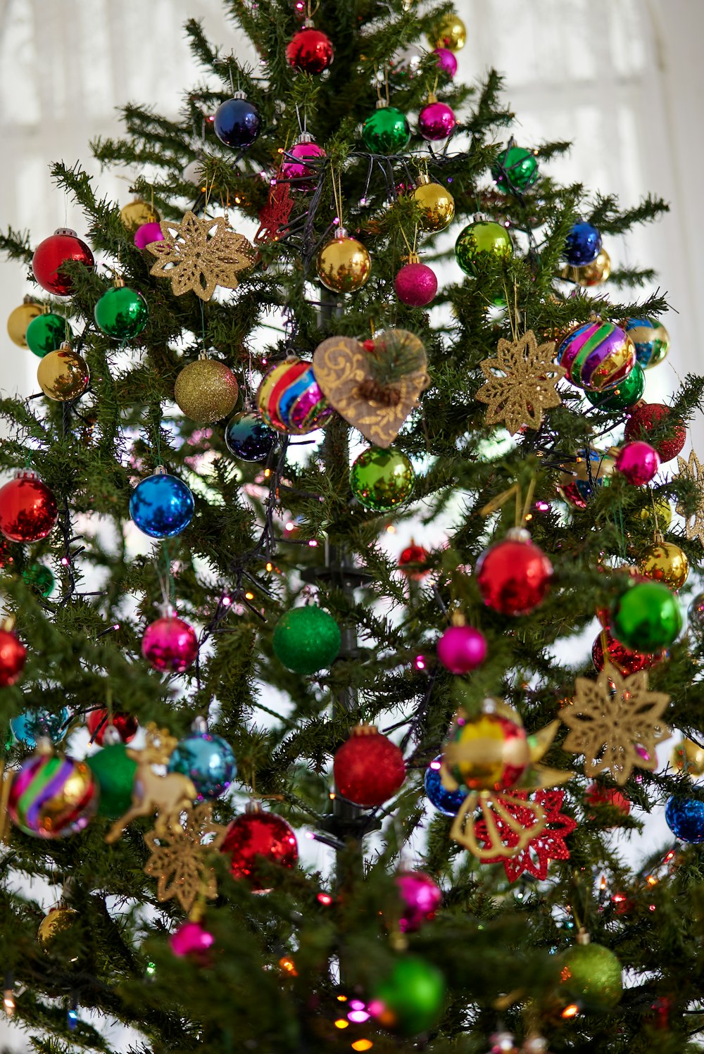 green red and gold christmas tree with baubles