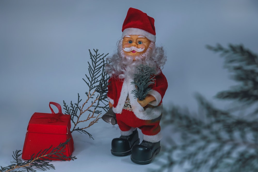 santa claus figurine on white snow