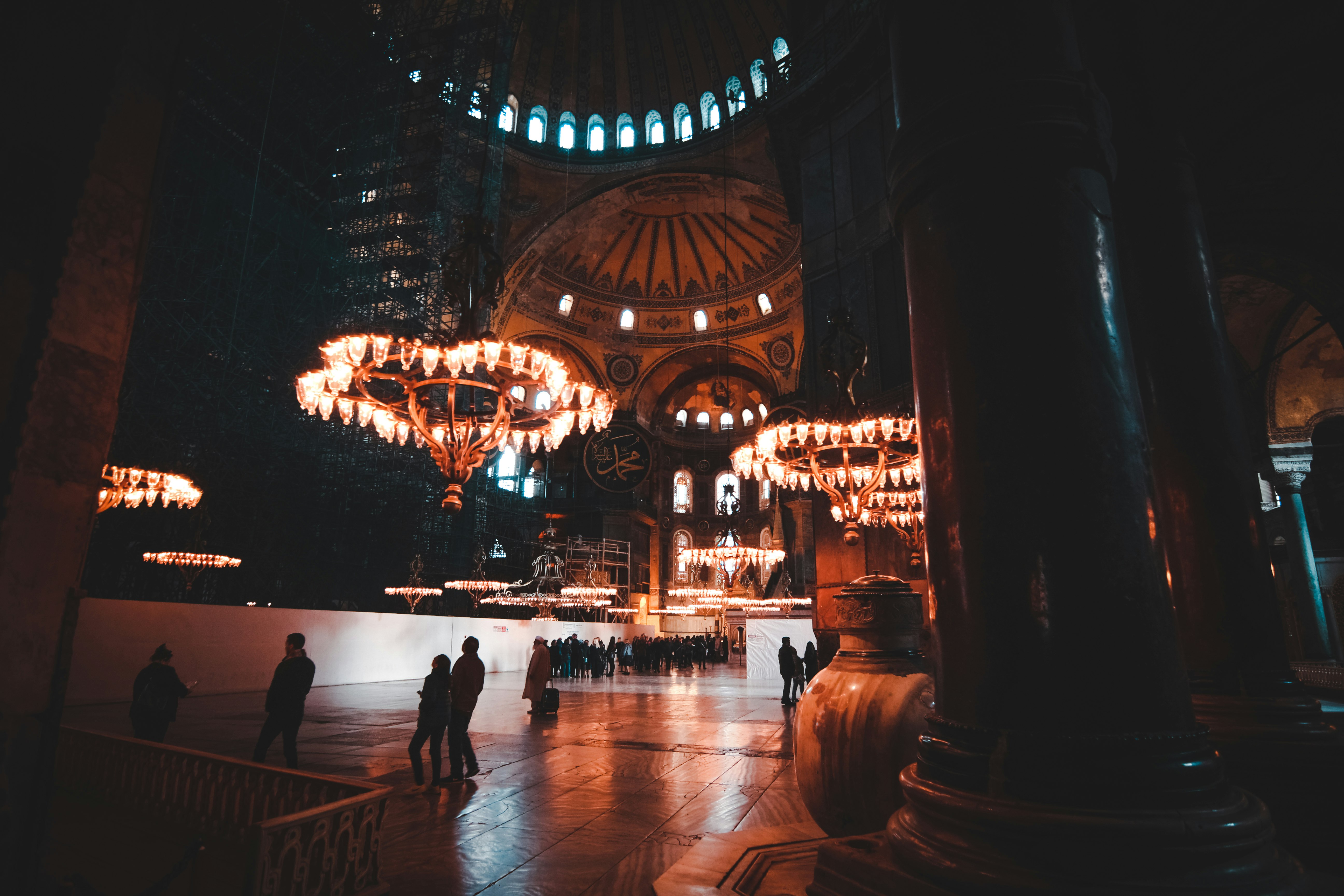 people standing on brown wooden floor during night time