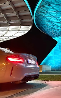 A sleek car illuminated by neon lights, symbolizing futuristic AI-driven insurance.