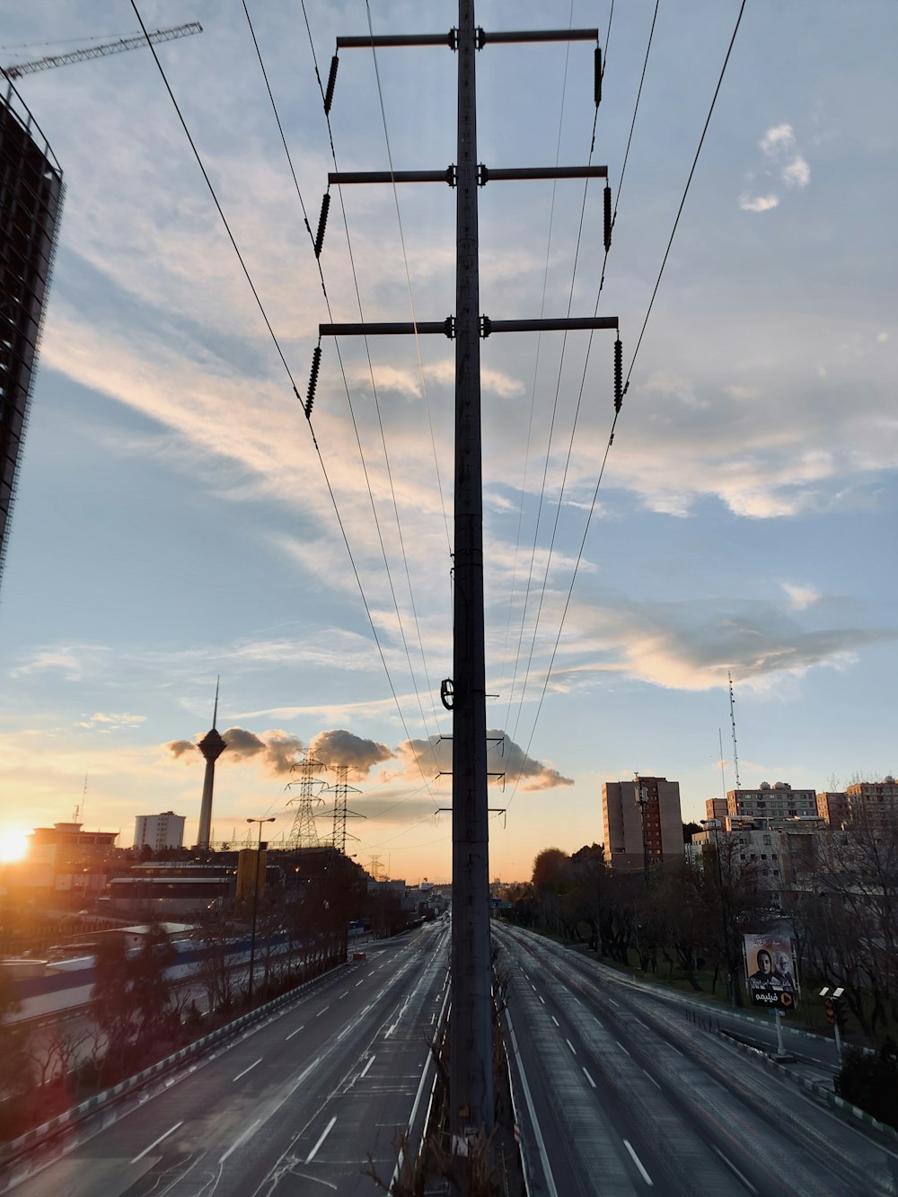 black electric post near road during daytime