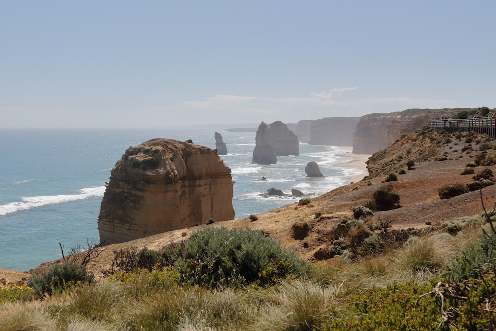 brown rock formation near body of water during daytime