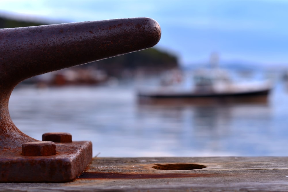 black metal pipe on brown wooden surface