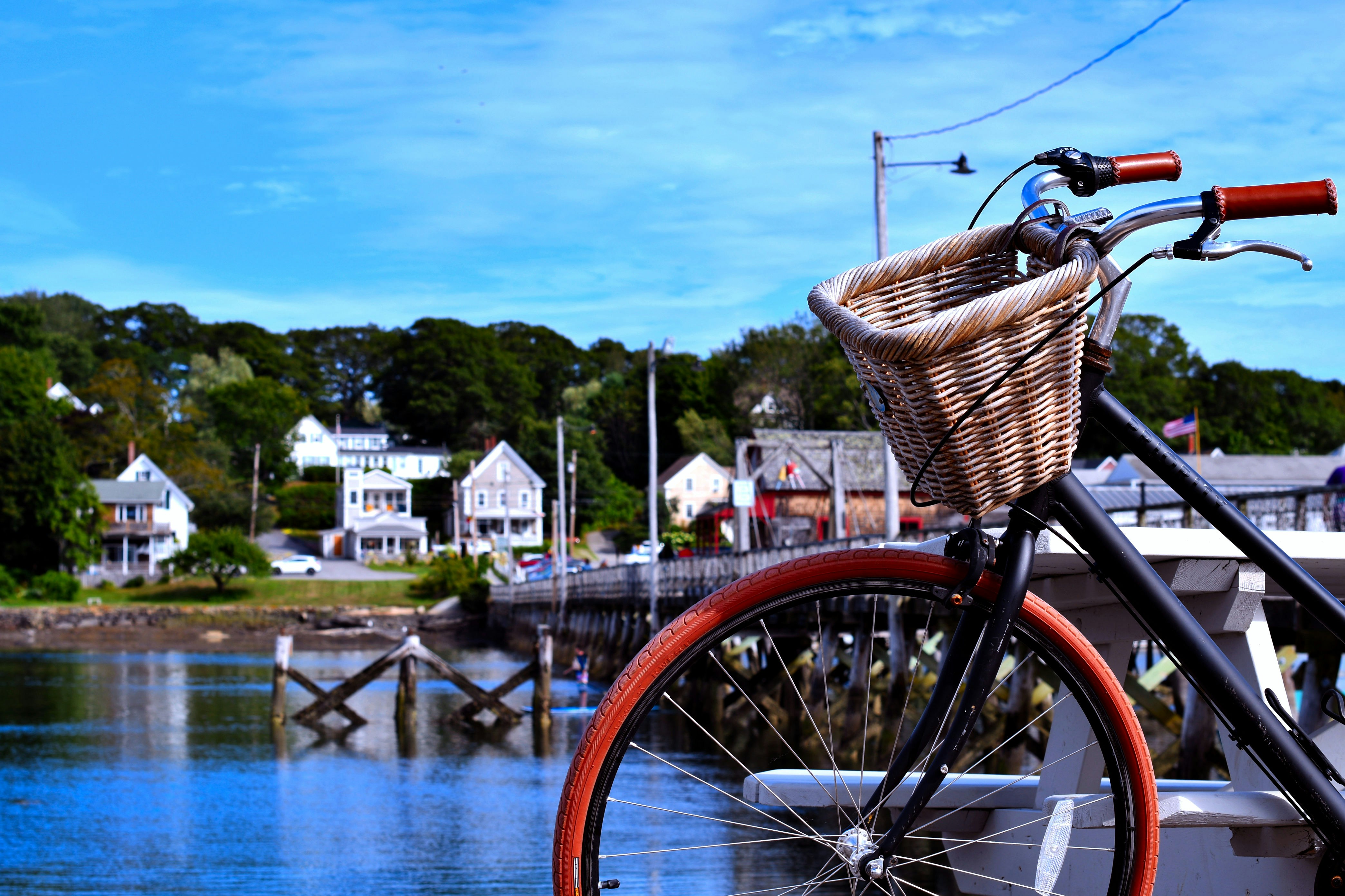 red city bike near body of water during daytime