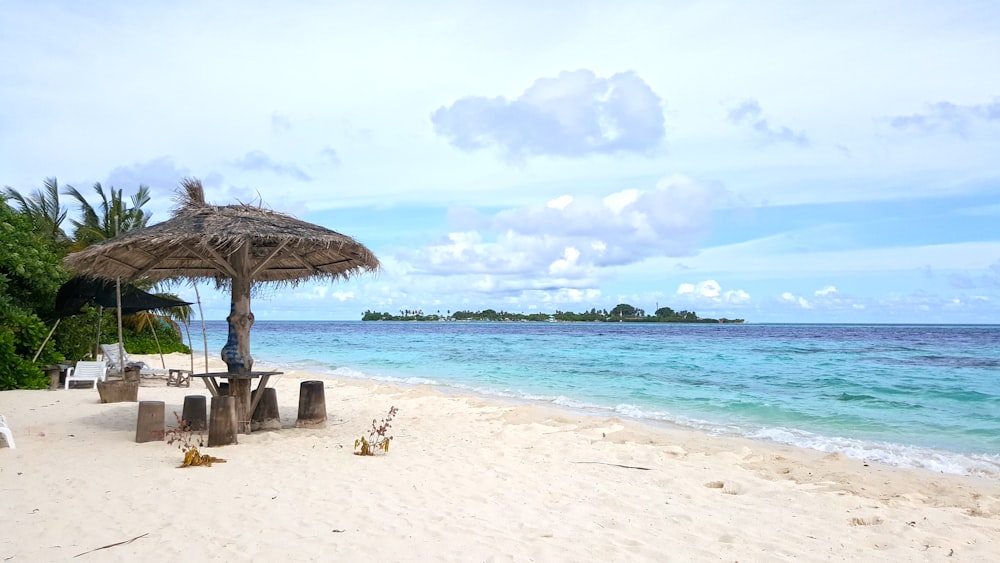 brown beach umbrellas on beach during daytime