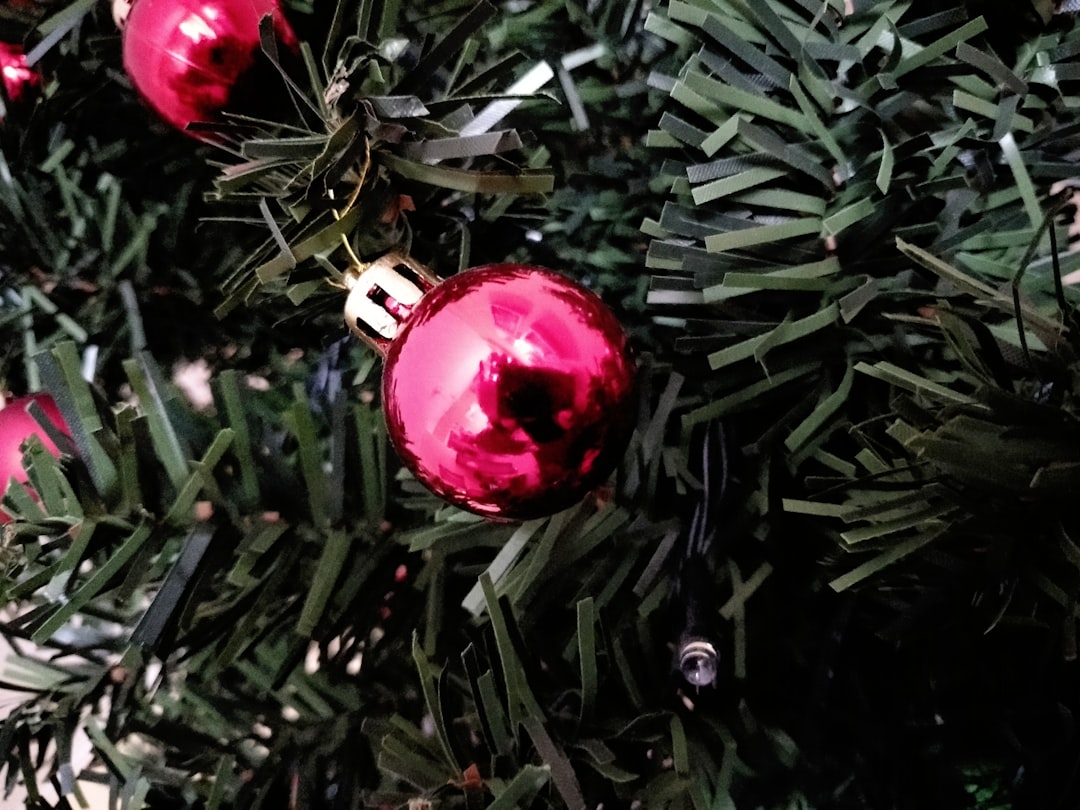 red baubles on green christmas tree