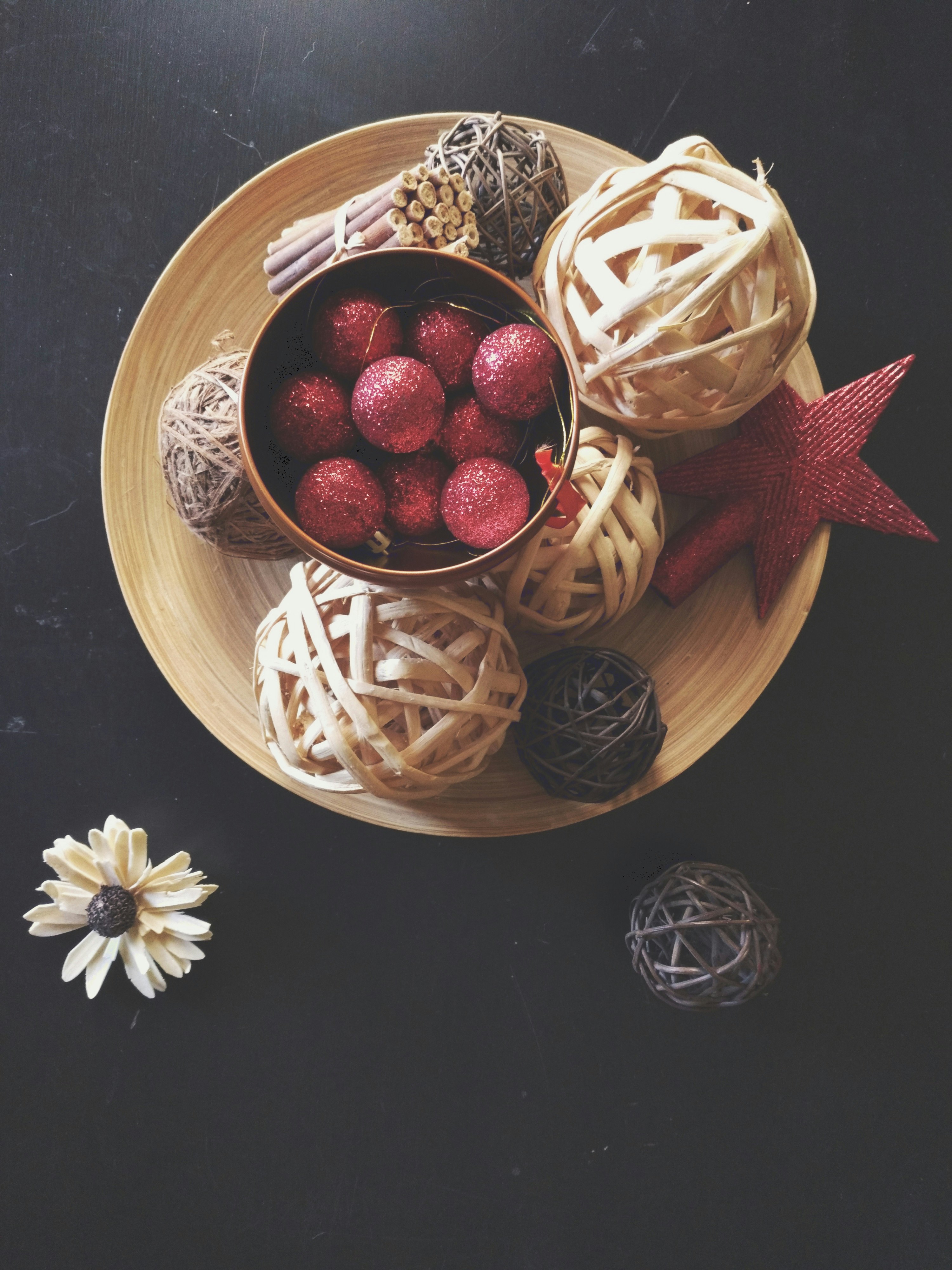red and white berries on brown wooden bowl