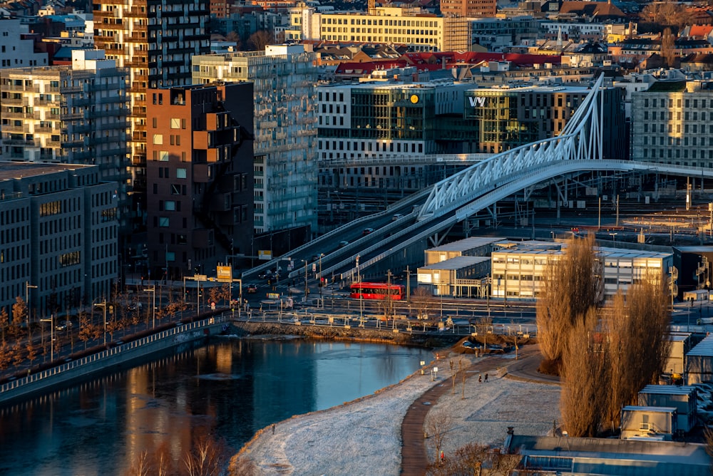 white bridge over river near city buildings during daytime