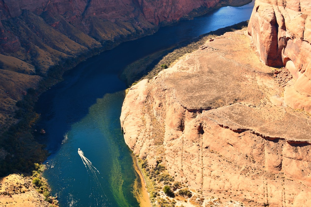 aerial view of brown mountain beside body of water during daytime