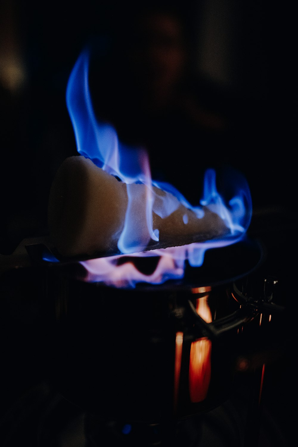 blue and white fire in black metal grill