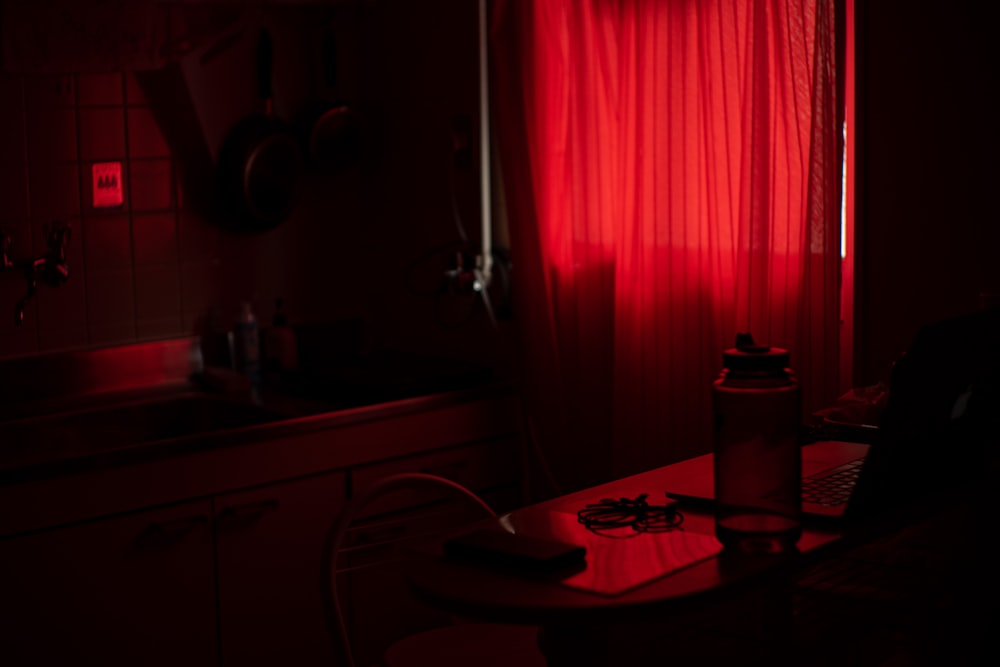 red window curtain near brown wooden table