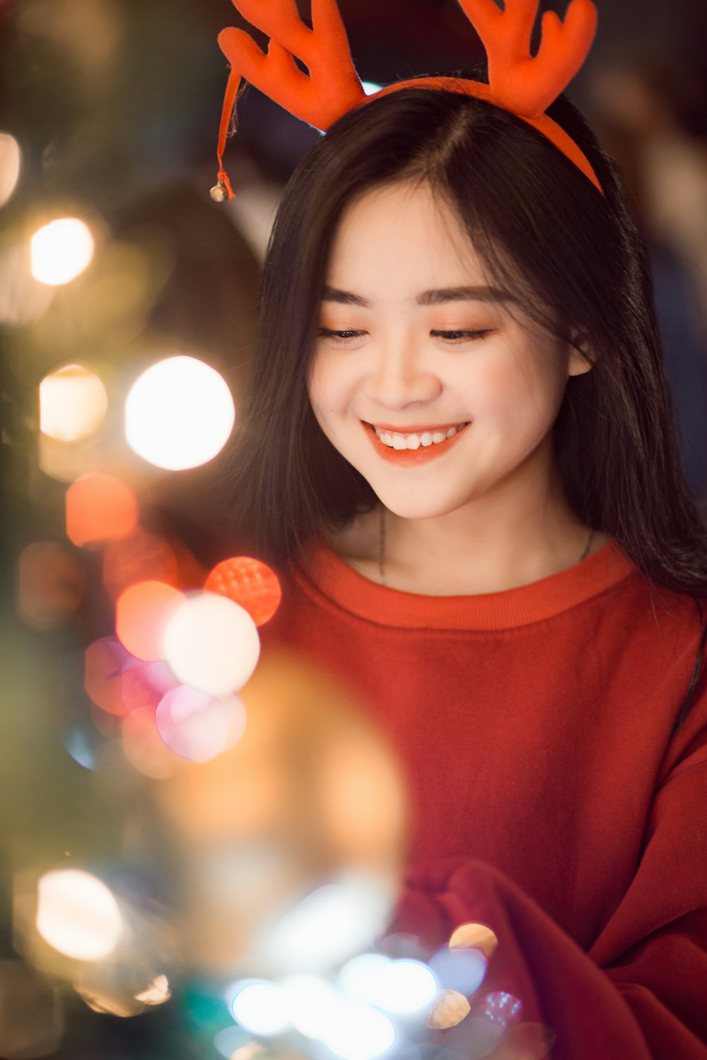 woman in red crew neck shirt smiling