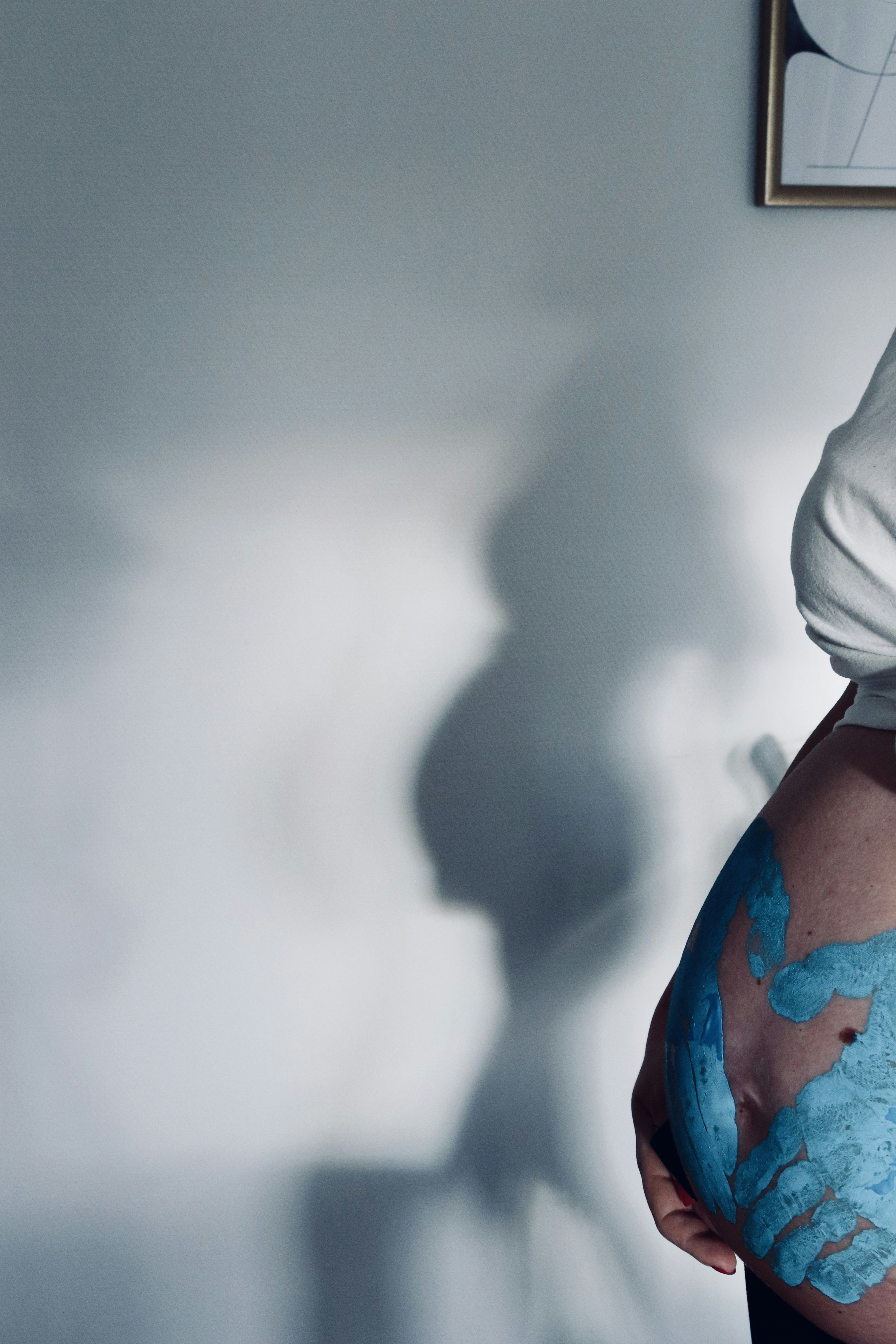 person in white hijab and blue and red floral shirt