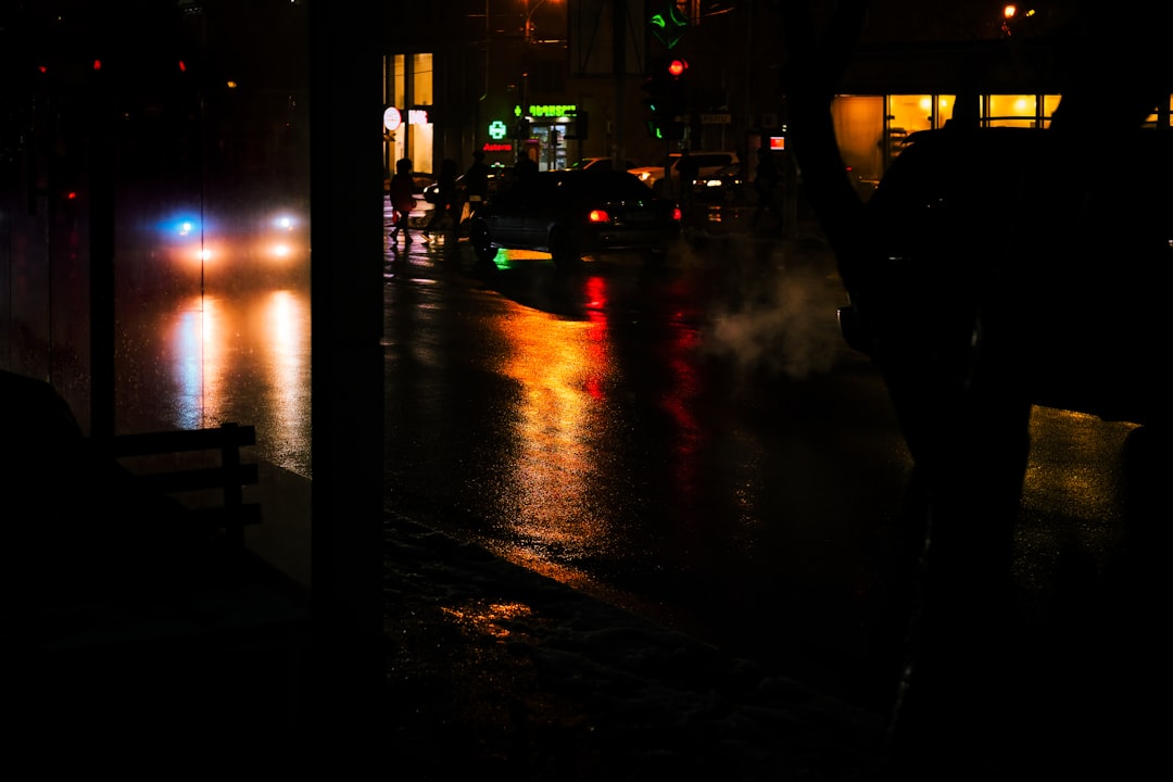 person standing on sidewalk during night time