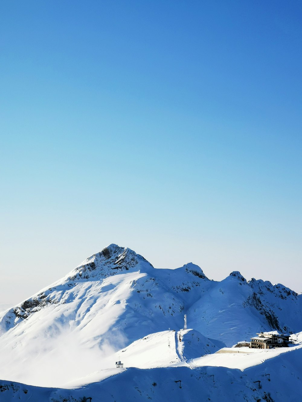 snow covered mountain under blue sky during daytime