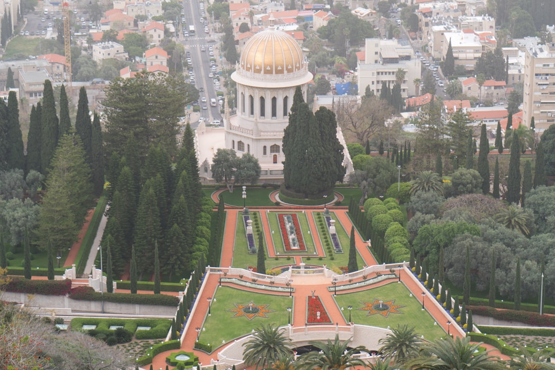 white and brown dome building surrounded by green trees during daytime