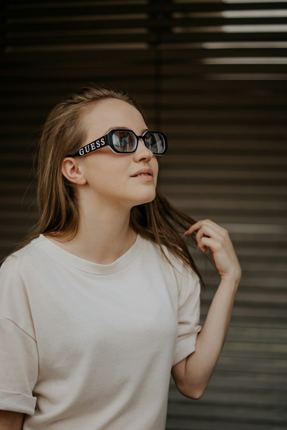 woman in white crew neck t-shirt wearing black framed sunglasses