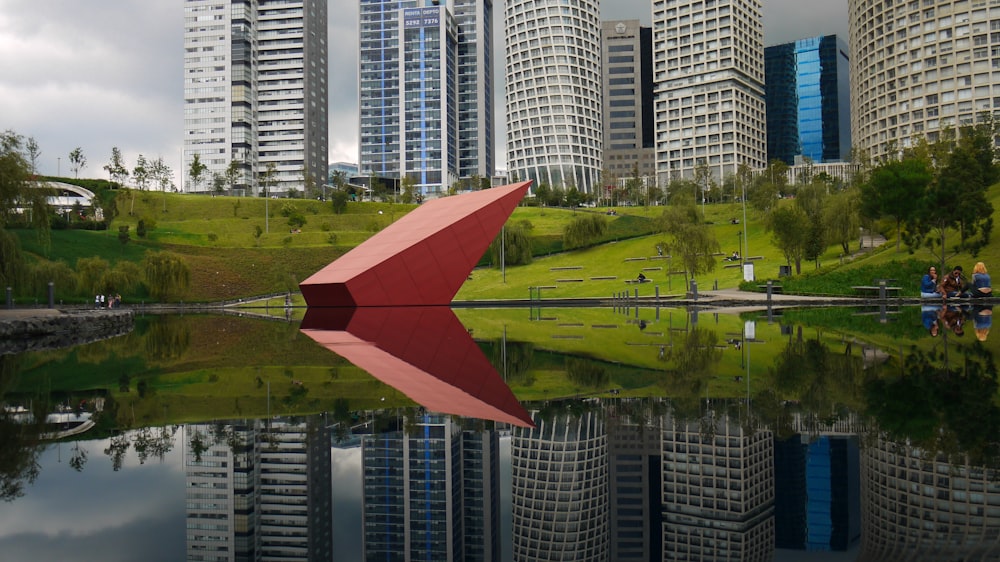 red umbrella near body of water during daytime