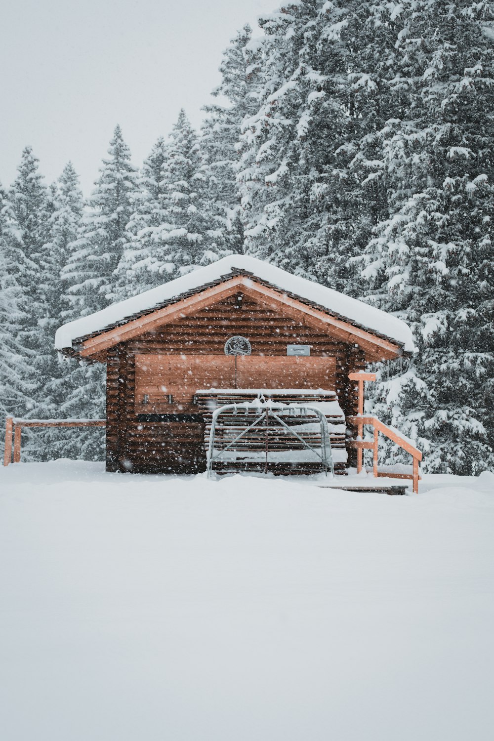 brown wooden house on snow covered ground