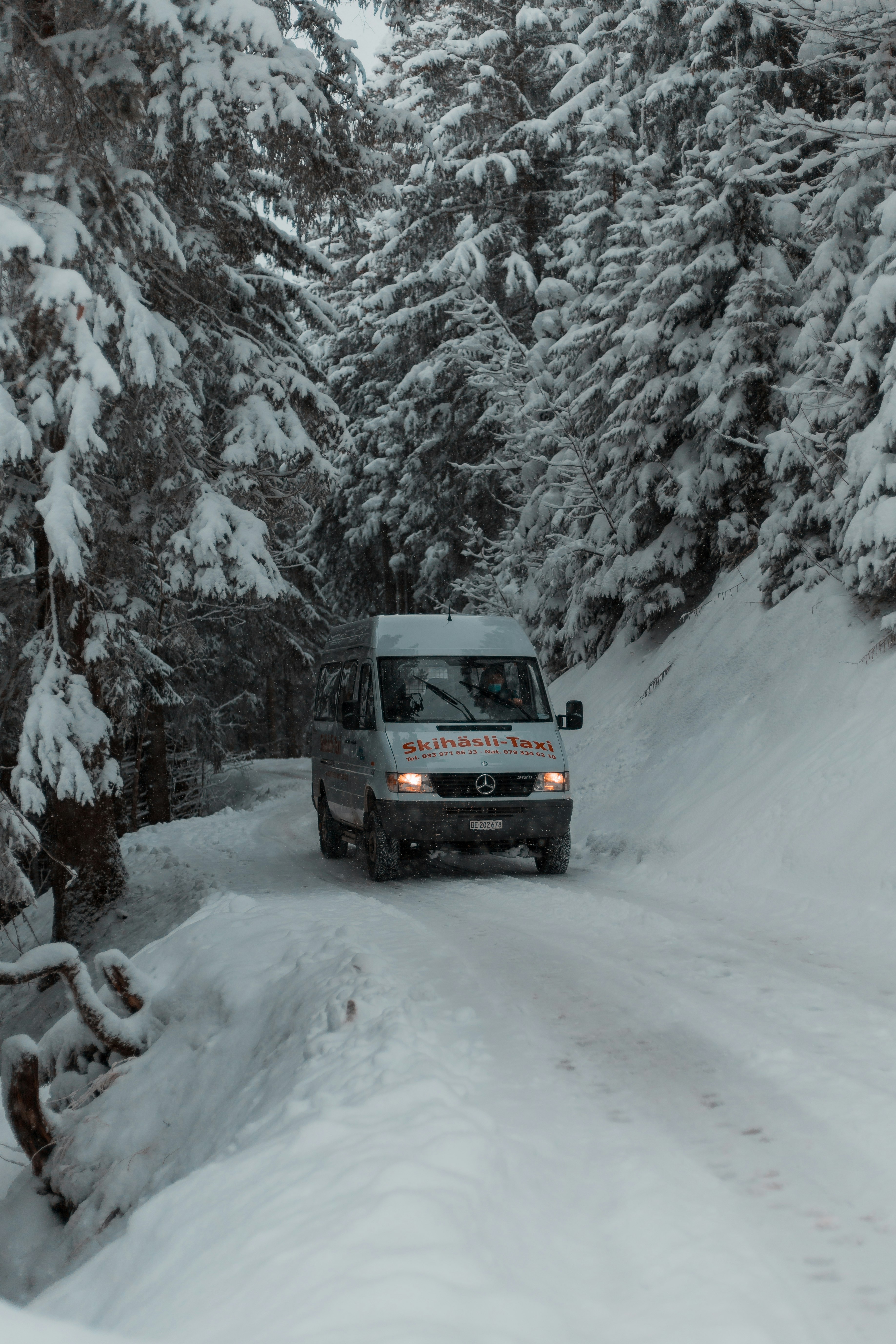 black suv on snow covered road during daytime