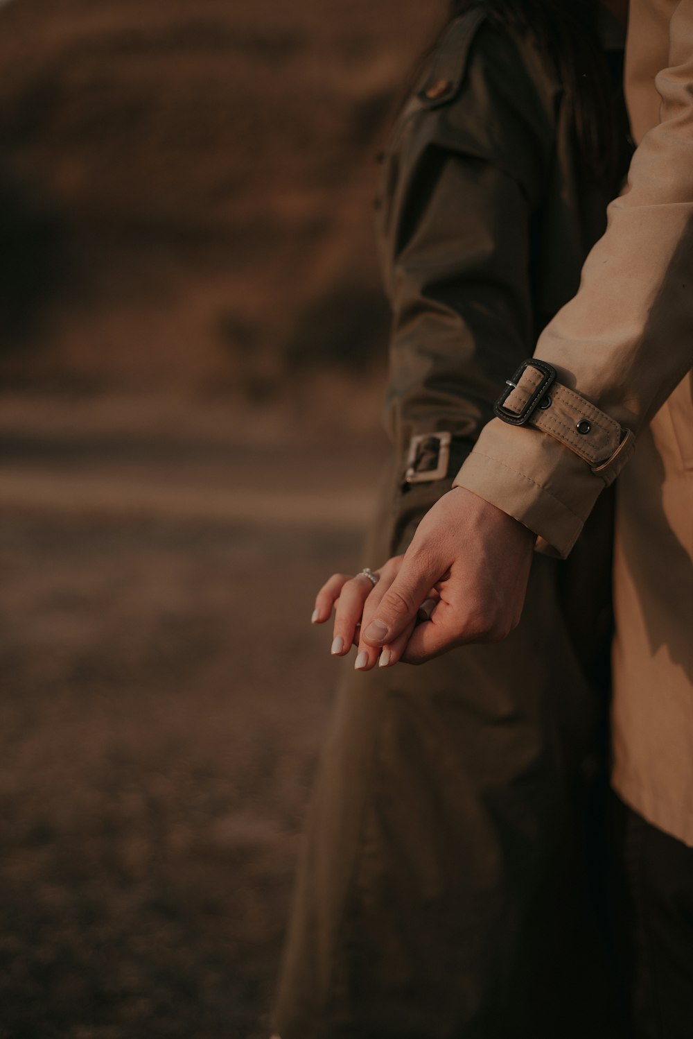 person in brown long sleeve shirt wearing silver watch