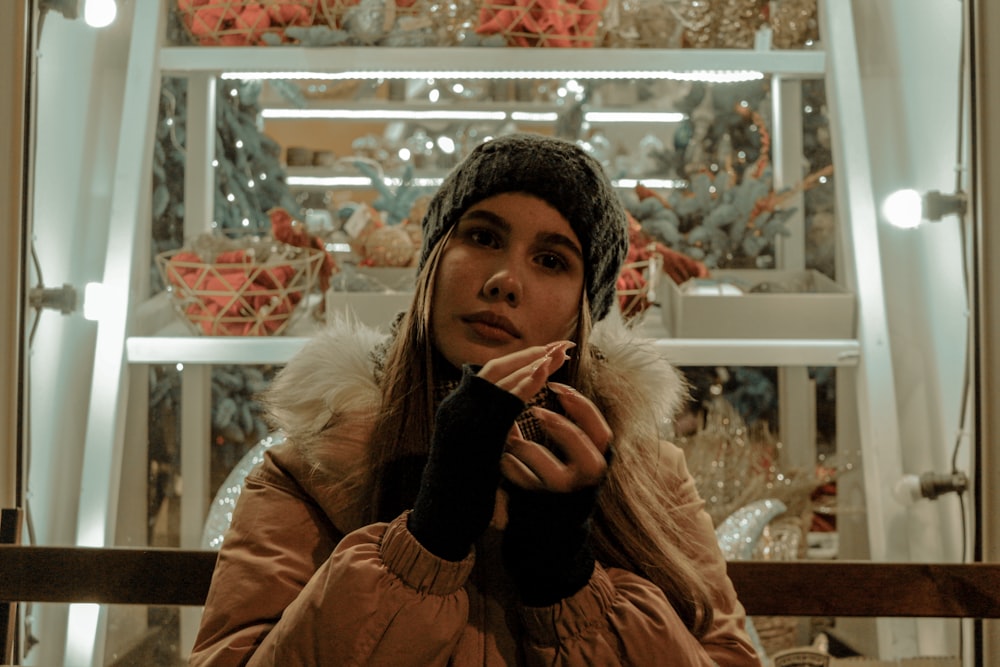 woman in brown fur coat holding black ceramic mug