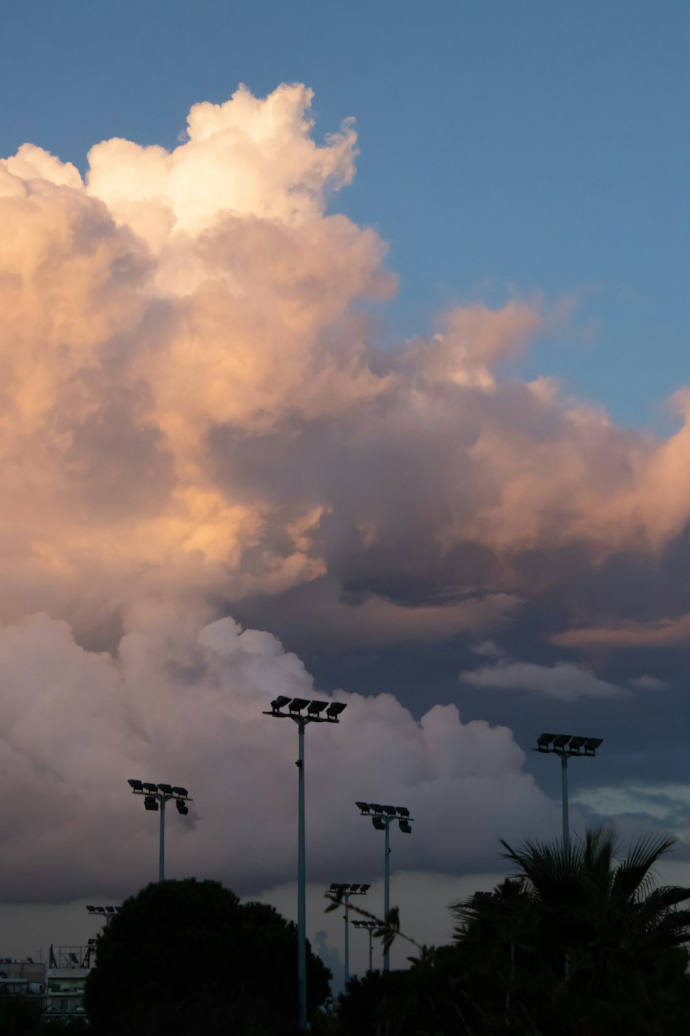 white clouds over black street light