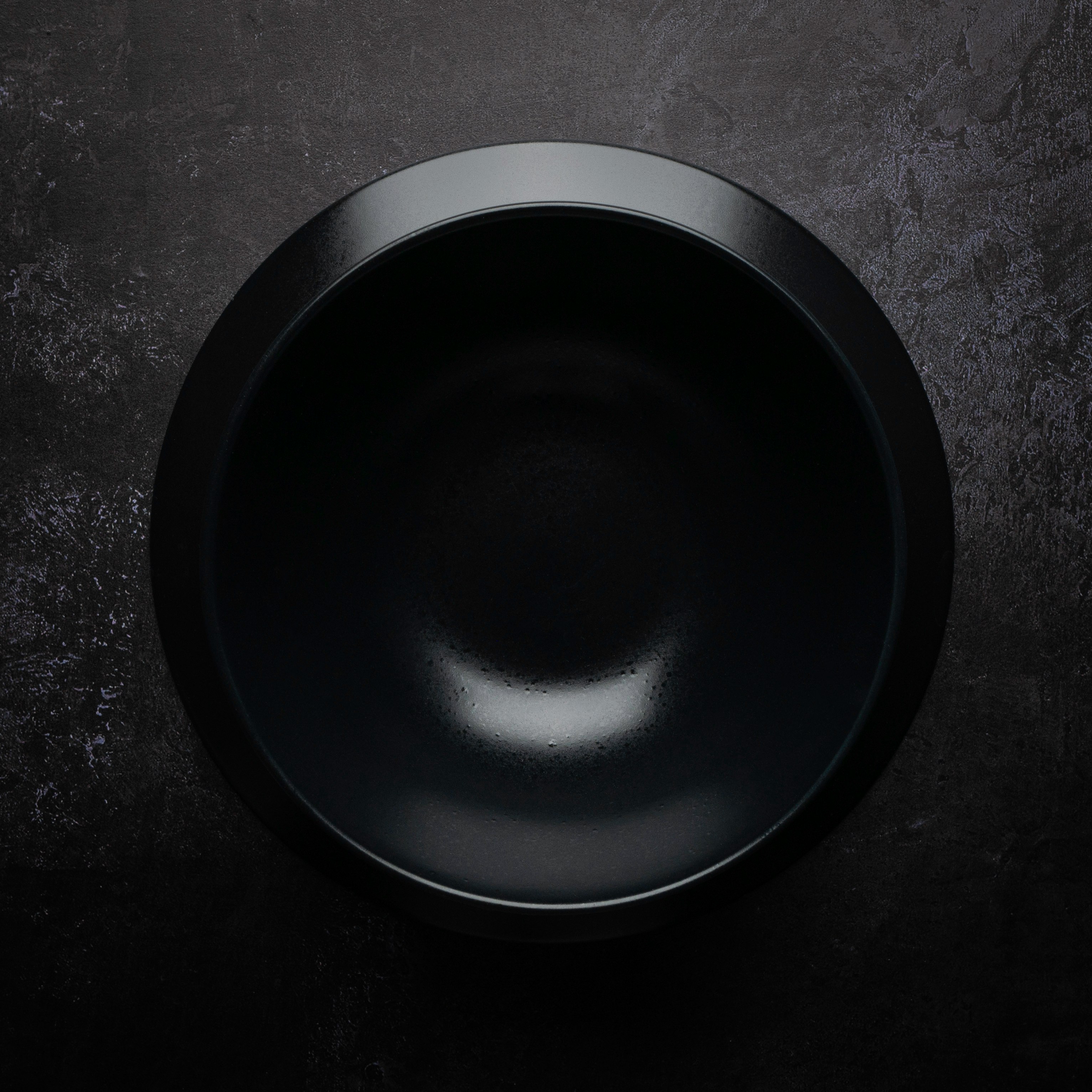 black round plate on black and gray surface