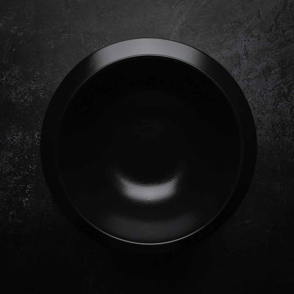 black round plate on black and gray surface