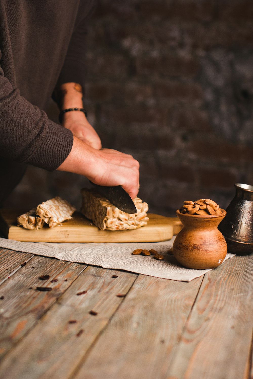 person holding brown wooden chopping board