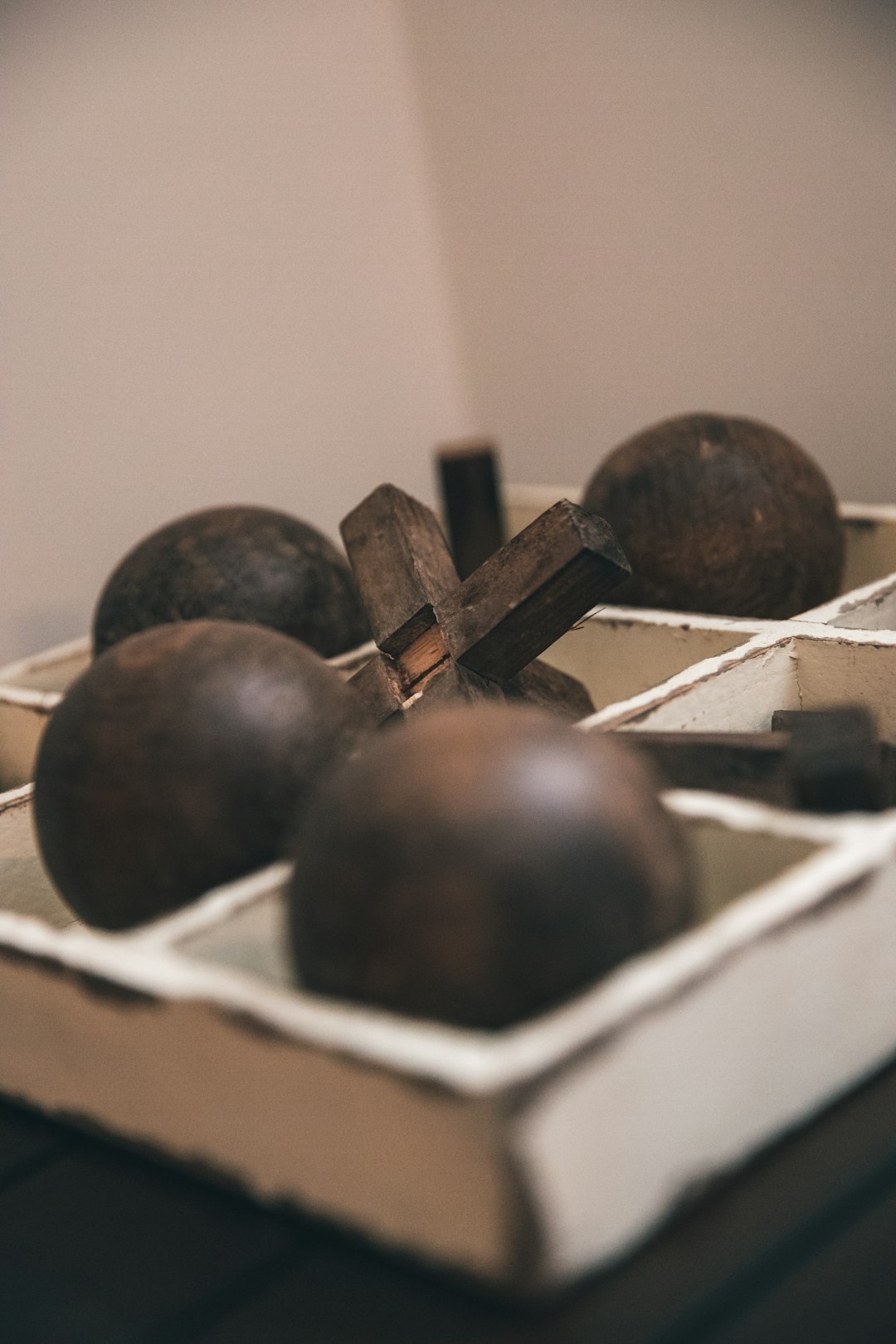 black round fruit on white wooden rack