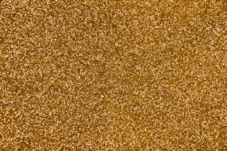 Rich golden yellow pigment powder shimmering under light.