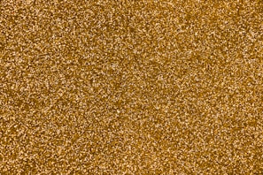 Rich golden yellow pigment powder shimmering under light.