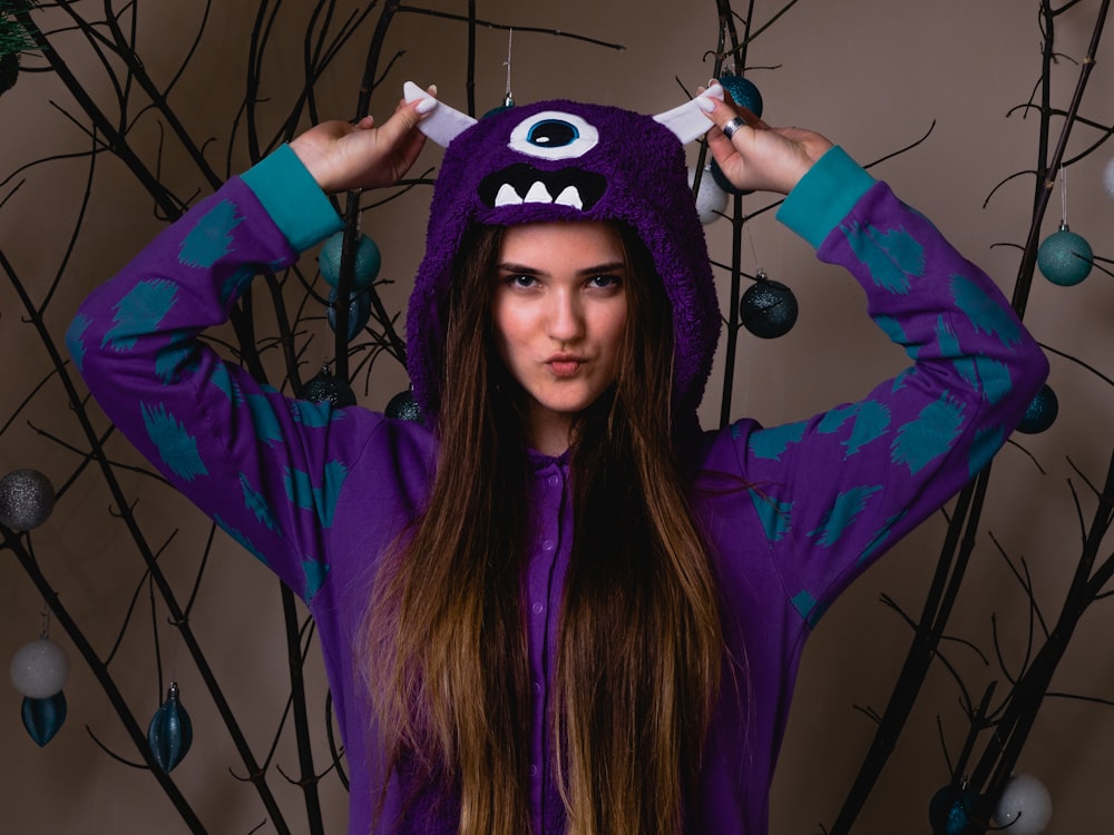 woman in blue and purple long sleeve shirt wearing blue and white mask