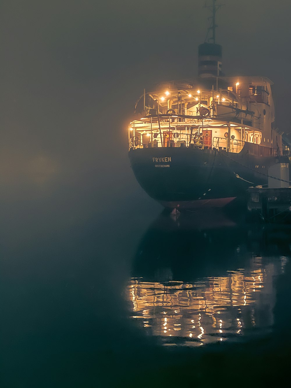 blue and white ship on water during night time