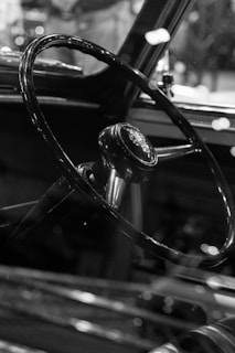 Close-up of a vintage steering wheel with warm ambient lighting.