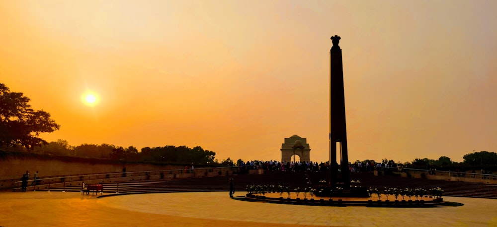 silhouette of people walking on park during sunset