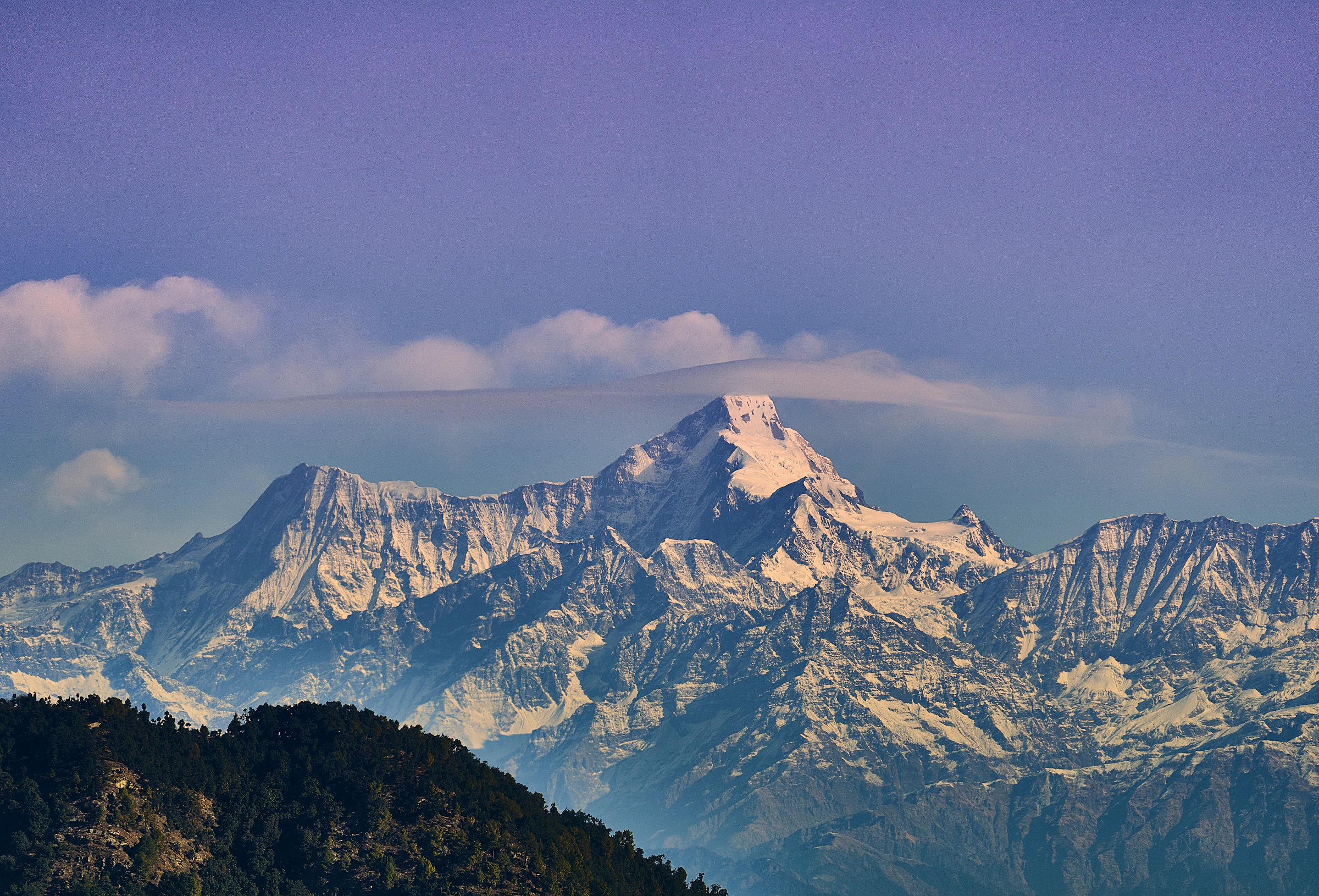 Snow-covered Himalayan peak under grey sky, Uttarakhand