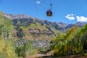 cable car over green trees and mountain during daytime