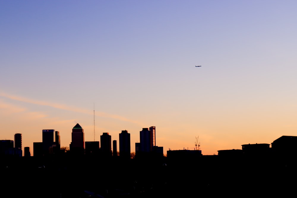 silhouette of city buildings during sunset