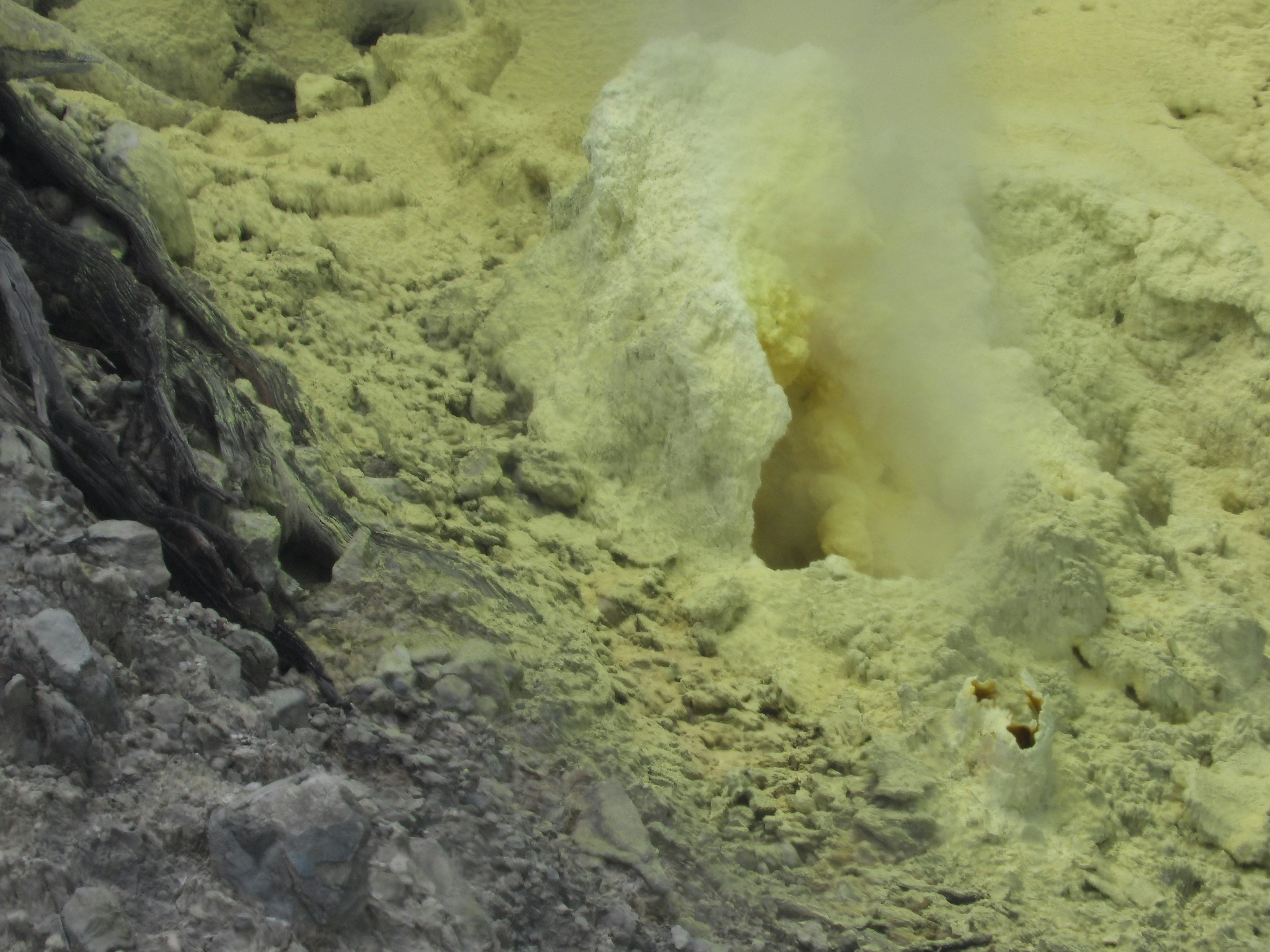 Volcanic sulphurous valley with steaming vents and otherworldly rocky landscape