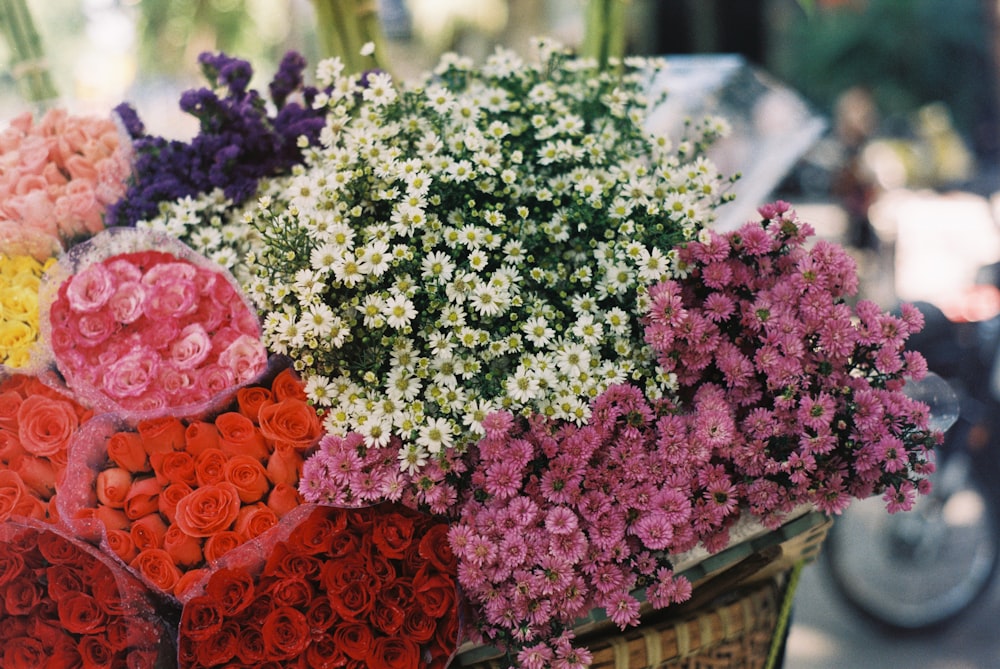 pink and white flowers on brown woven basket