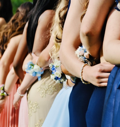 woman in blue sleeveless dress wearing blue and white floral tiara