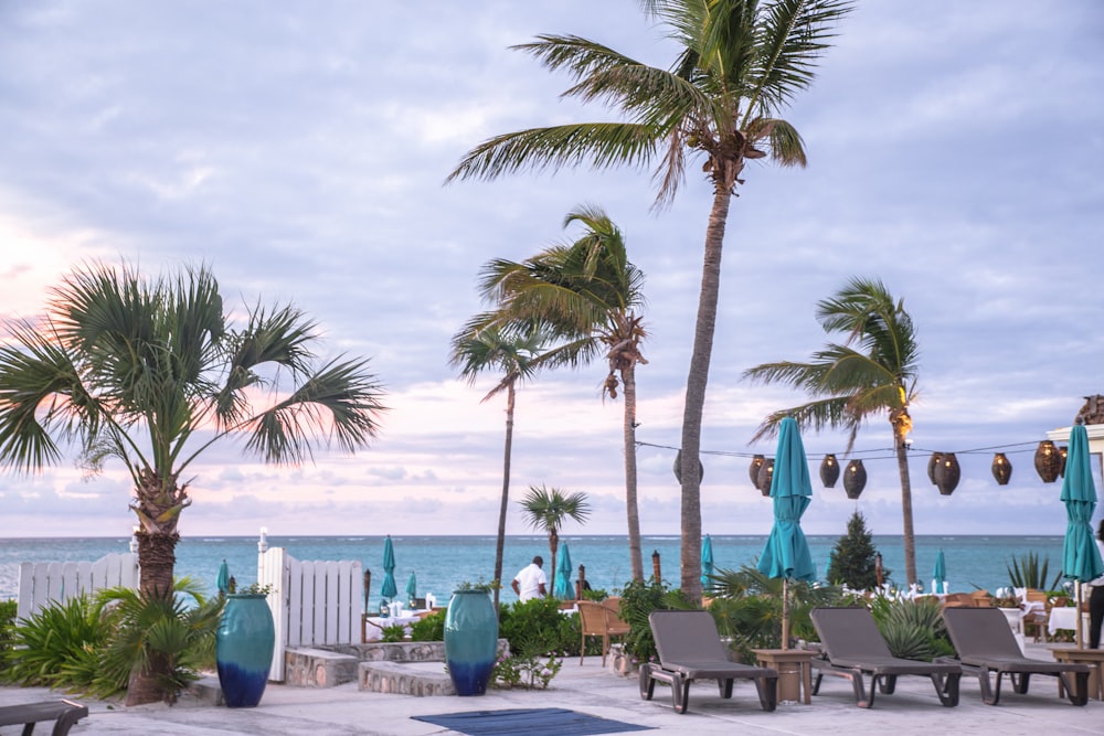 white wooden table and chairs near beach during daytime